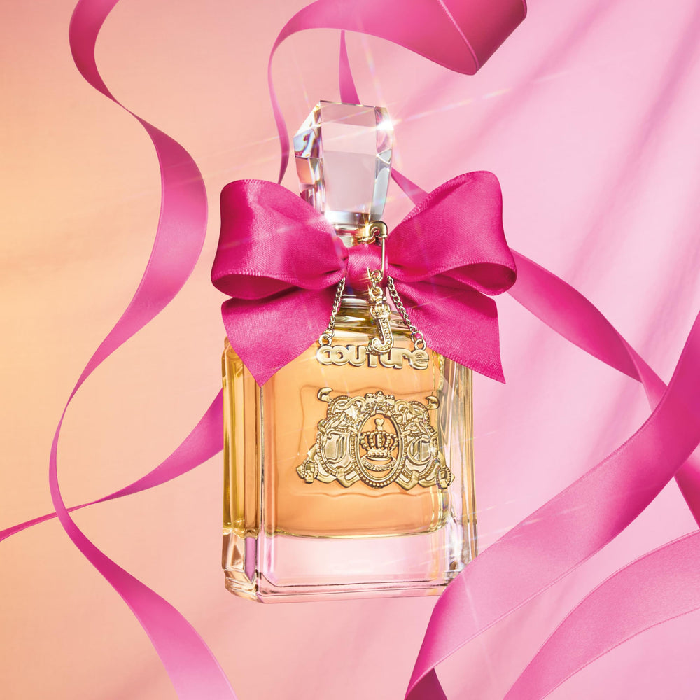 Juicy Couture Viva La Juicy bottle with golden cap, luxury feel.