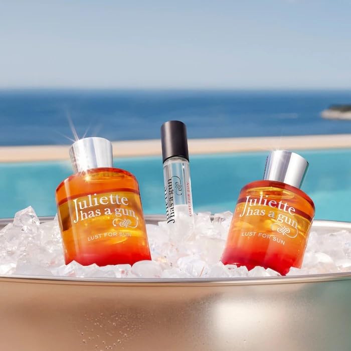 Juliette Has A Gun Lust for Sun bottle glowing in sunlight, warm summer vibes.