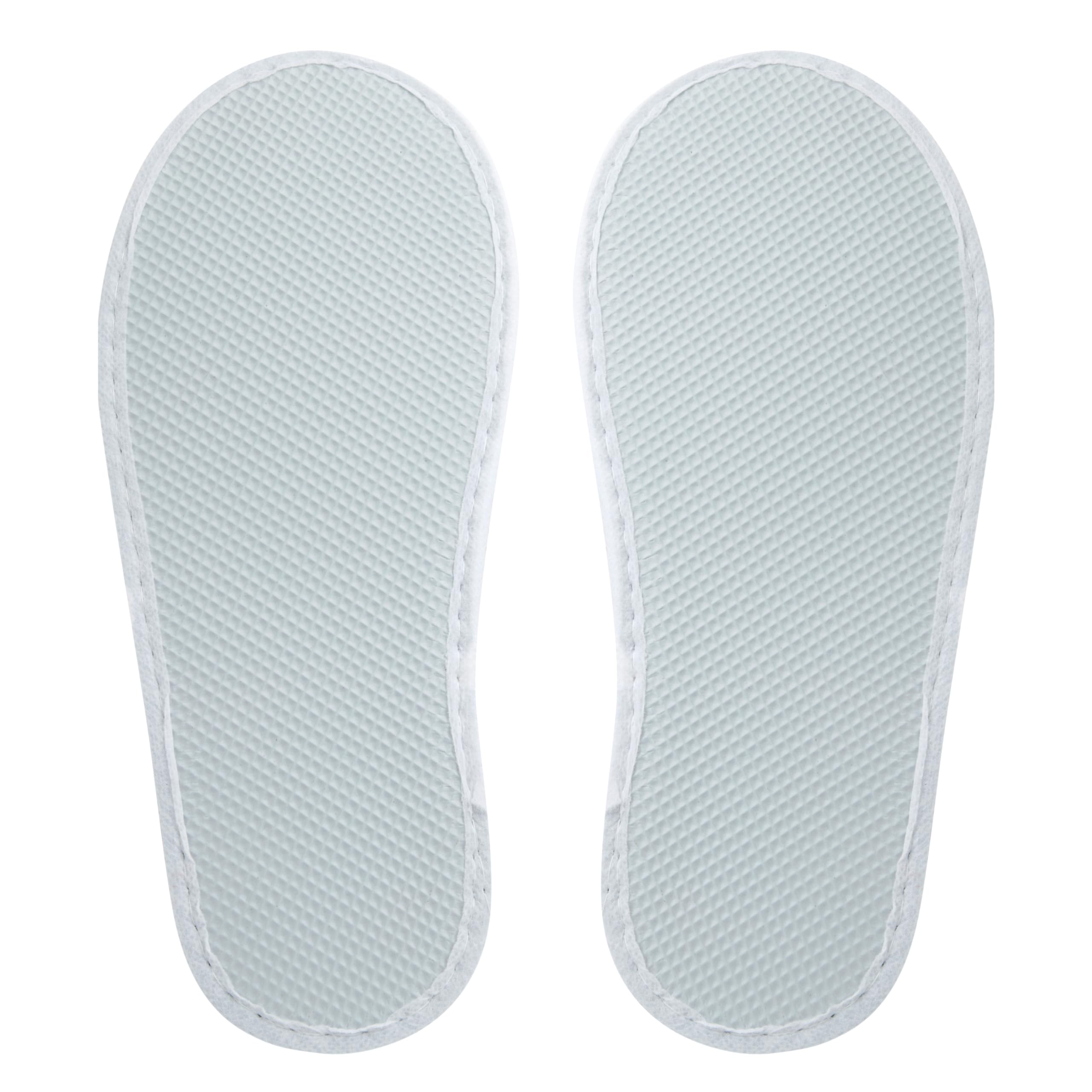 Juvale hotel room setup with slippers ready for guests.