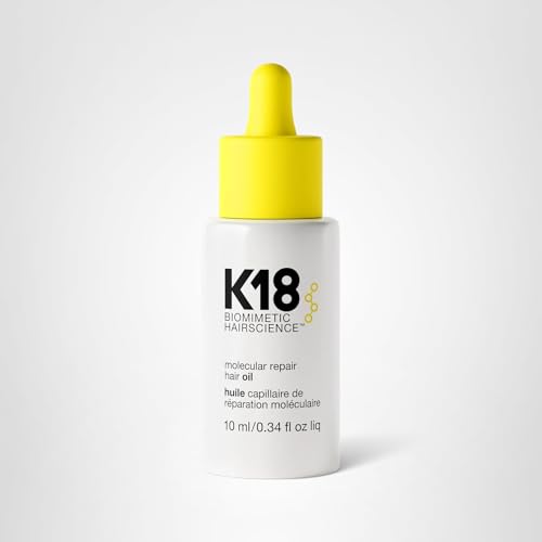 K18 Molecular Repair Hair Oil bottle resting on a vanity stand.