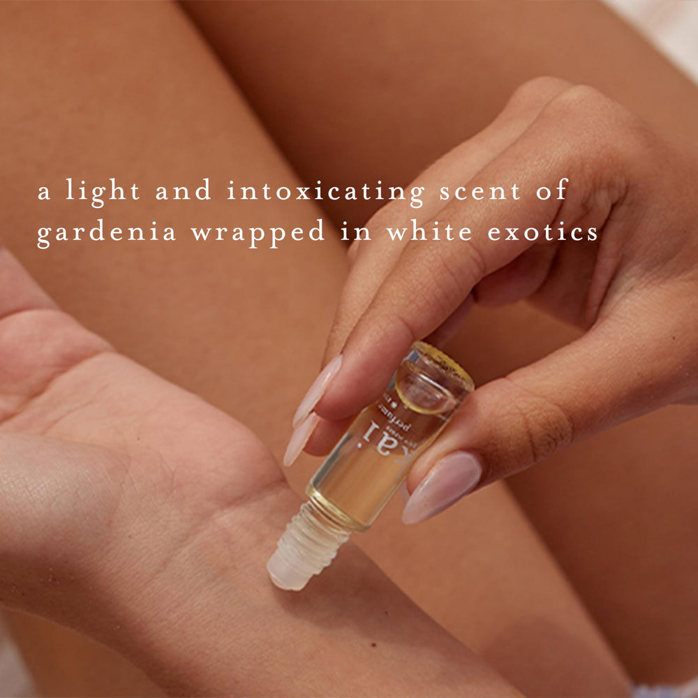 Kai perfume oil rolled-on wrist scene emphasizes subtle, uplifting gardenia aroma.