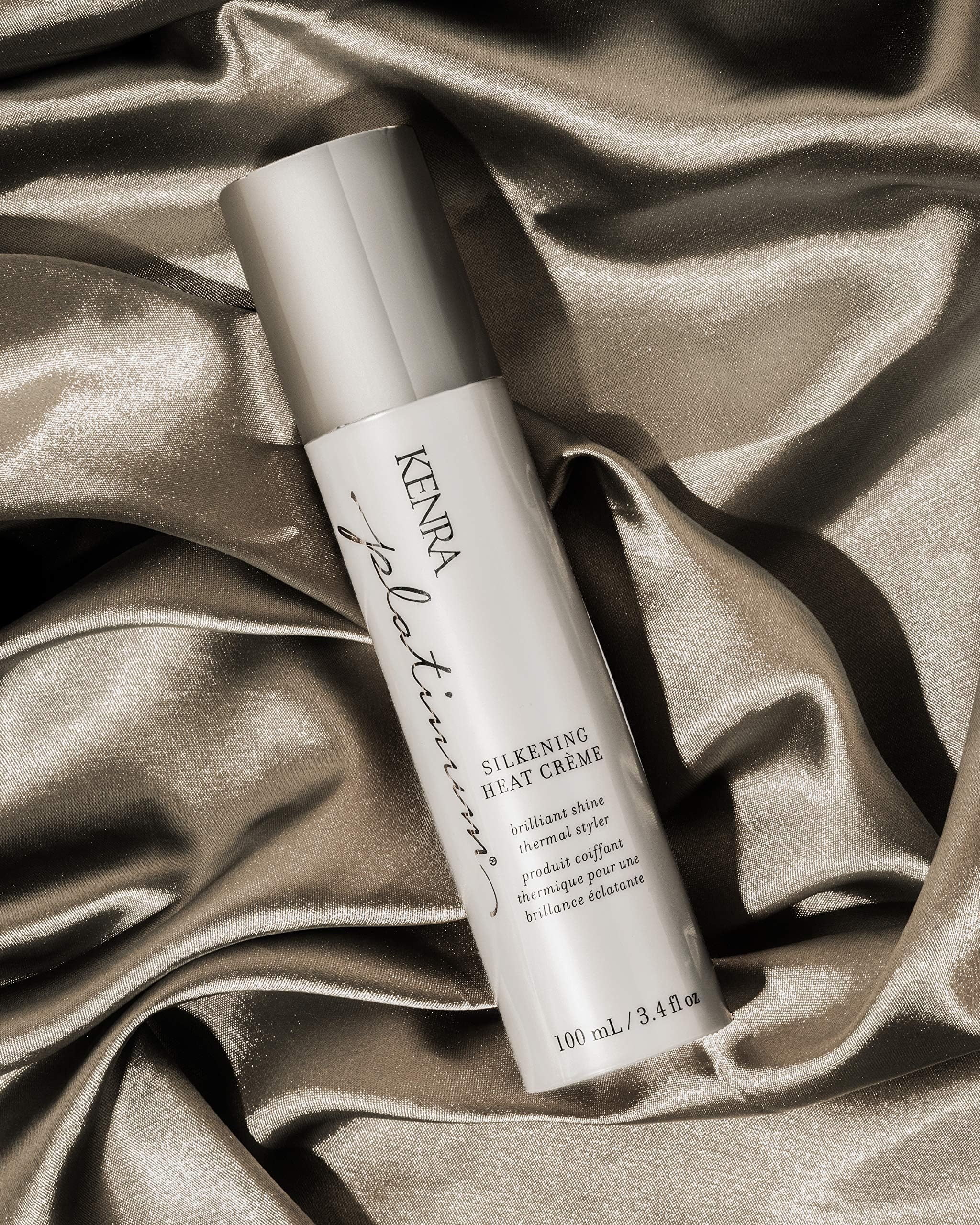 Hands applying Kenra Platinum Silkening Heat Crème for smoothing prep