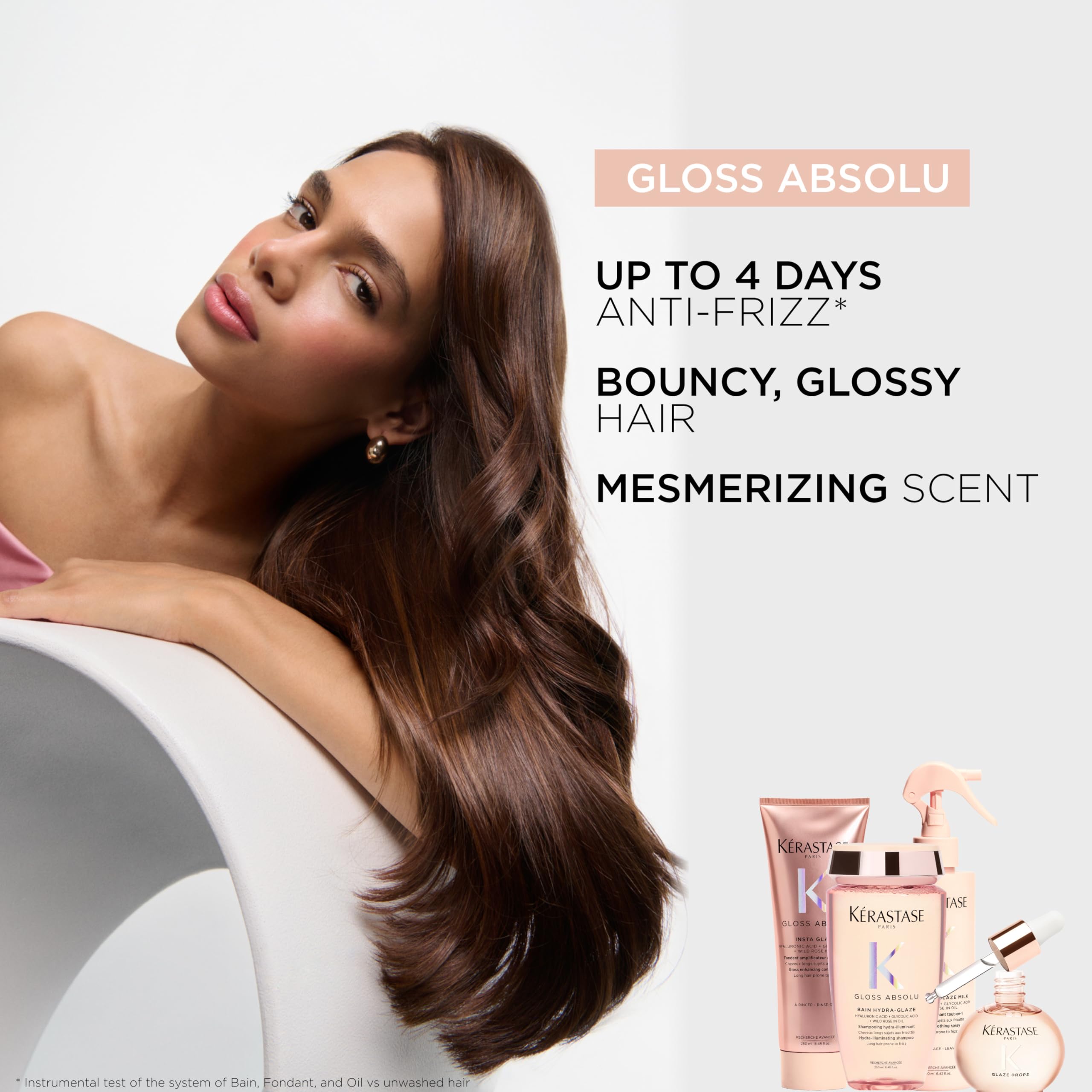 KÉRASTASE Gloss Absolu travel-size packaging on mirror for easy use.