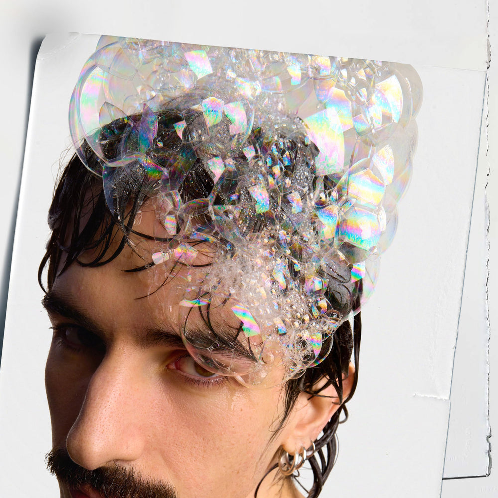 Applying Kiehl's Amino Acid Shampoo to wet hair for gentle cleansing.