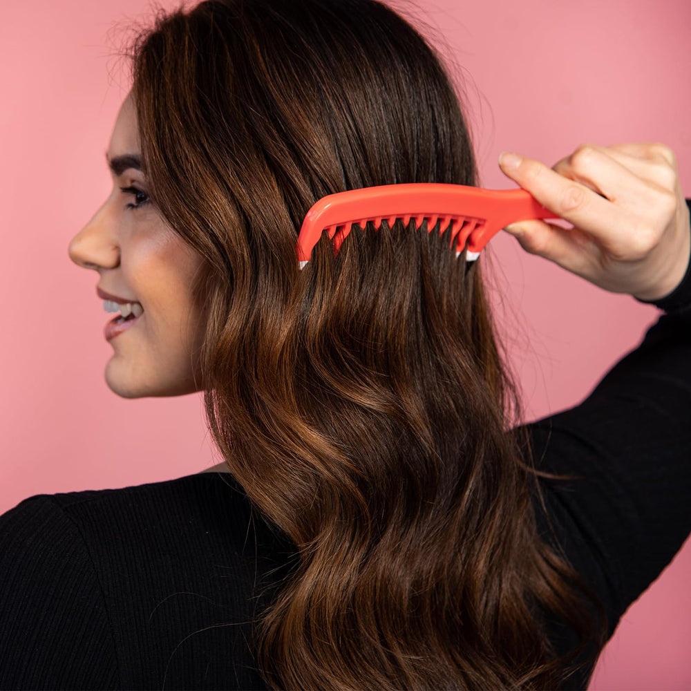 KISMETICS orange dual-teeth design close-up for faster detangling.