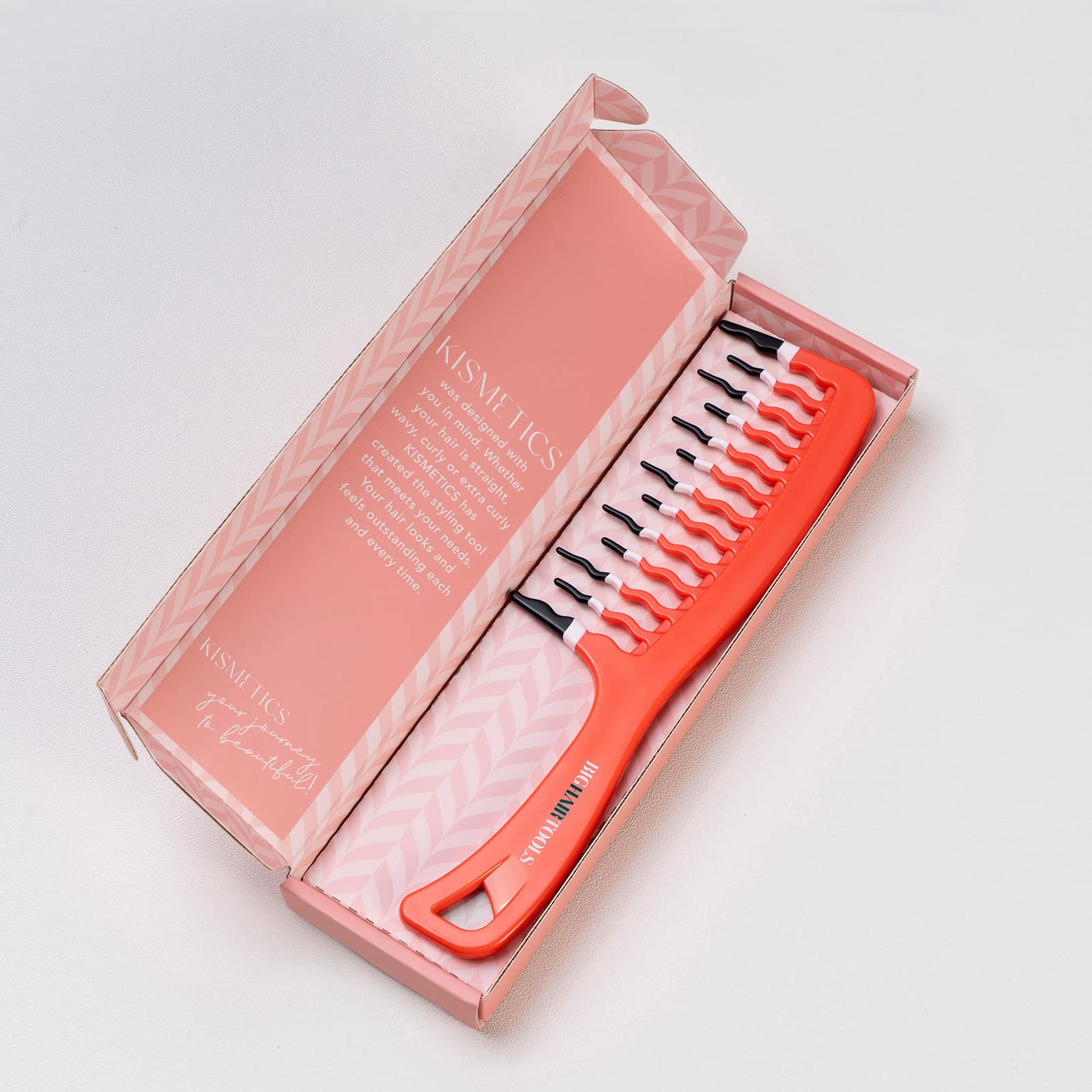 KISMETICS orange wide-tooth comb used on long thick hair for easier detangling.