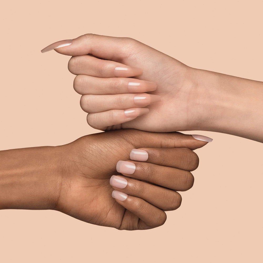 KISS press-on nails in pink square tips resting on a clean surface.