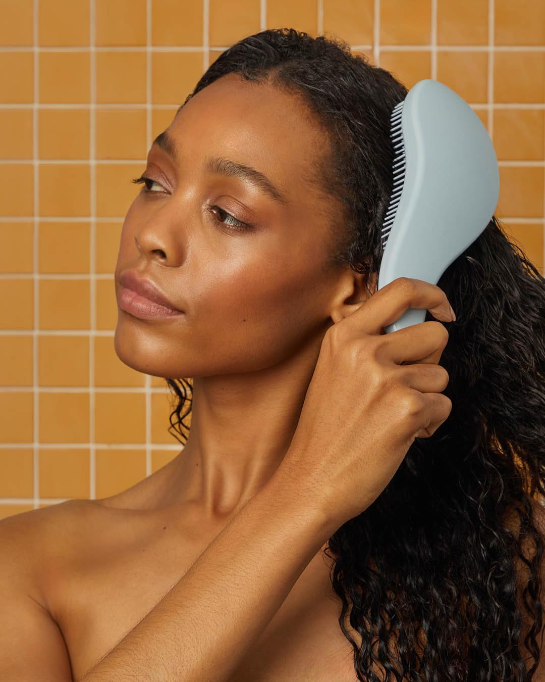Kitsch Detangler Brush in haze blue adds style to your routine.