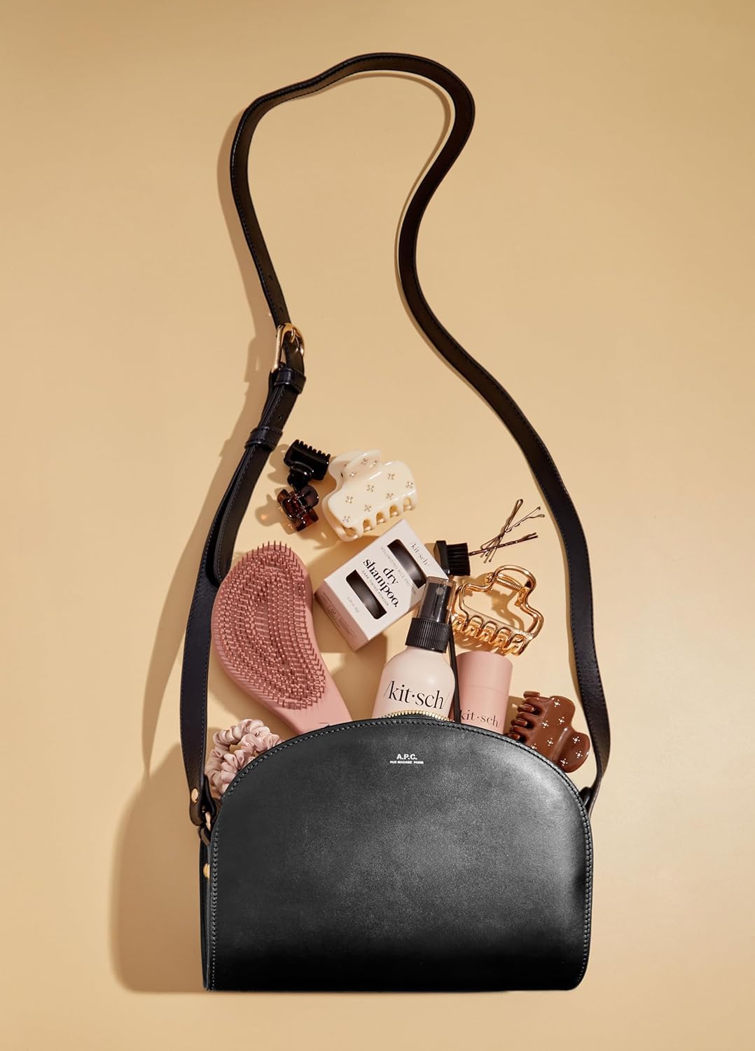 Kitsch Detangler Brush in terracotta color for stylish storage.