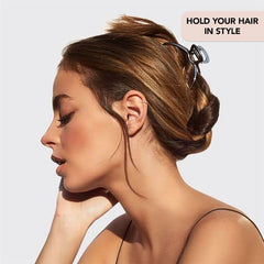 Kitsch hematite metal hair clip in hand demonstrates compact, travel-ready accessory