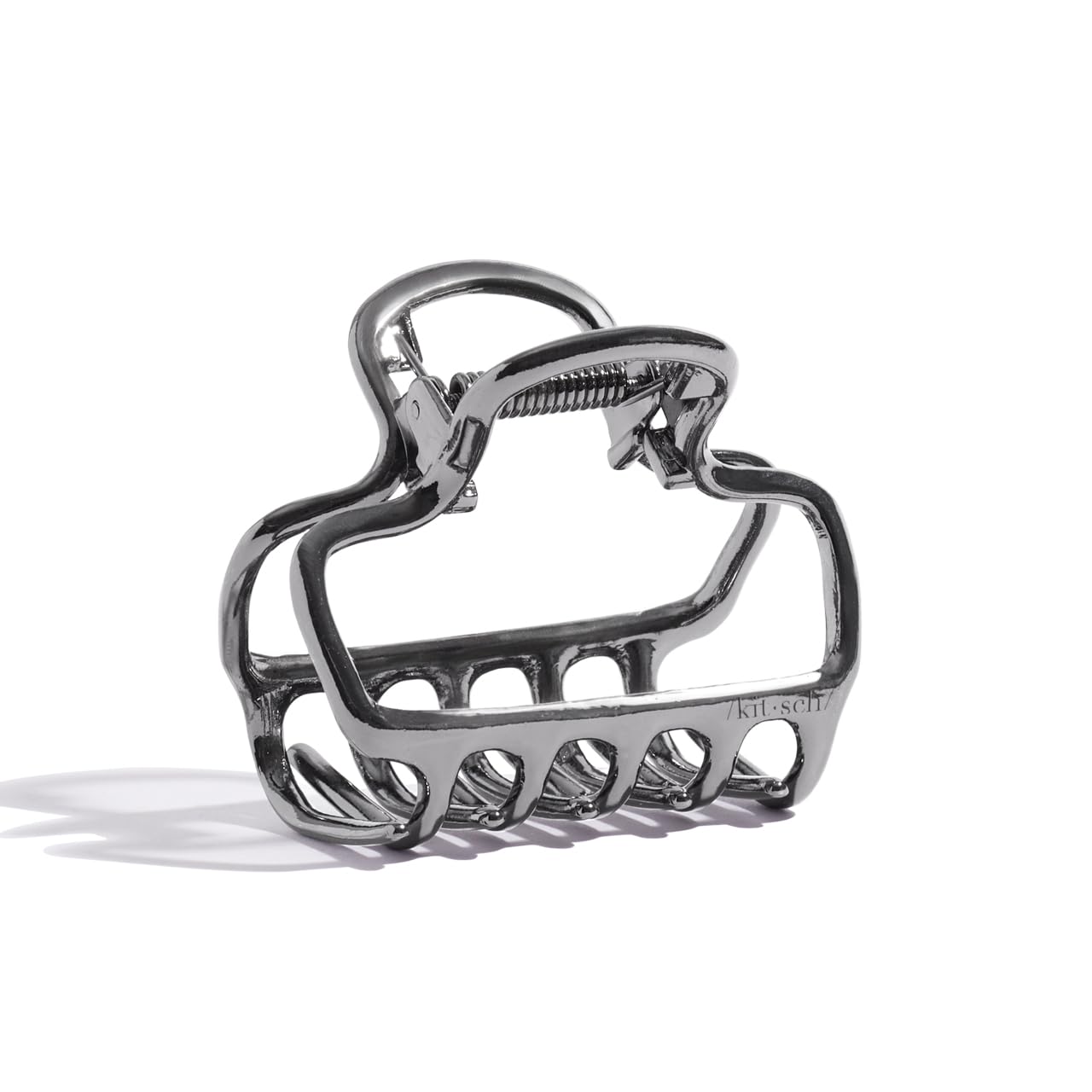 Kitsch open-frame hematite clip adds subtle shine to everyday hairstyles.