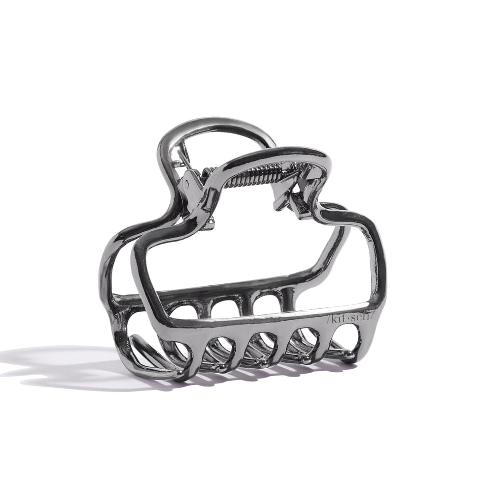 Kitsch open-frame hematite clip adds subtle shine to everyday hairstyles.