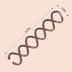Close-up of Kitsch spiral hair pins gripping hair gently for comfortable buns.