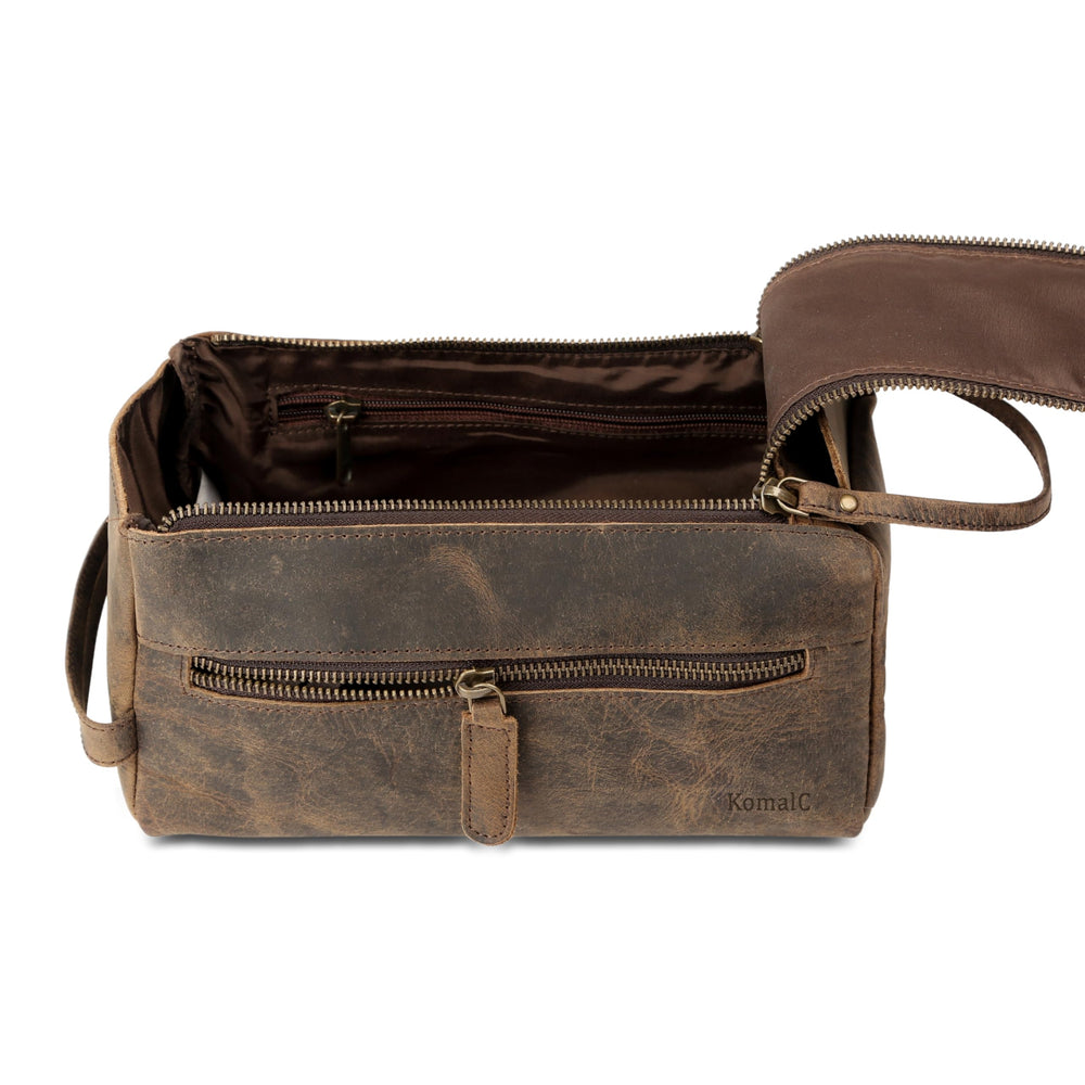 KomalC leather toiletry bag on stand demonstrates compact yet spacious design.