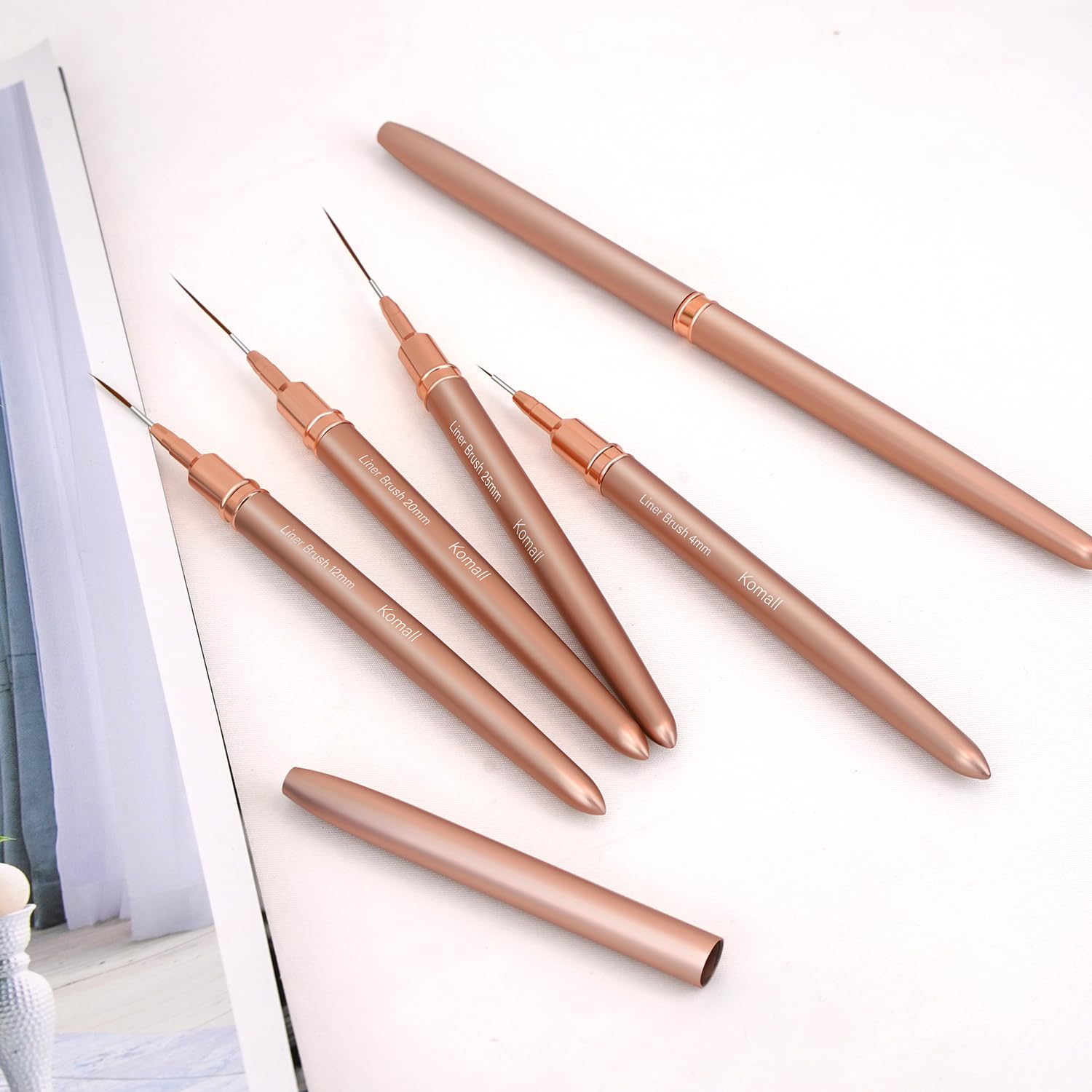 Komall Metallic Nail Art Brushes with rose gold ferrules offer balanced control and durability.