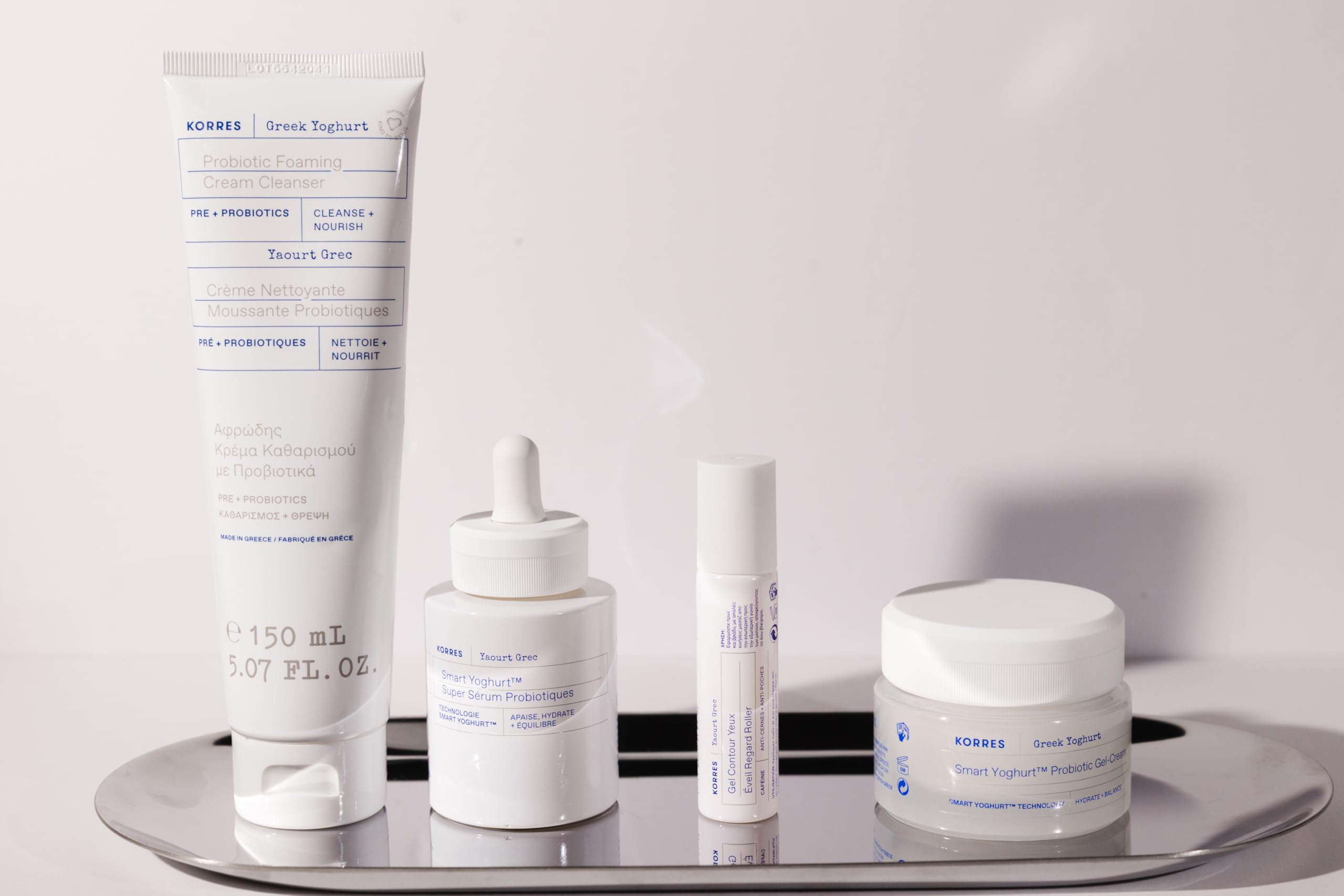 KORRES cleanser placed on a bathroom shelf with other skincare items.