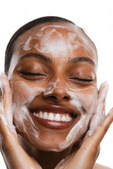 Dime-sized amount of KORRES cleanser on fingertips ready for facial massage.