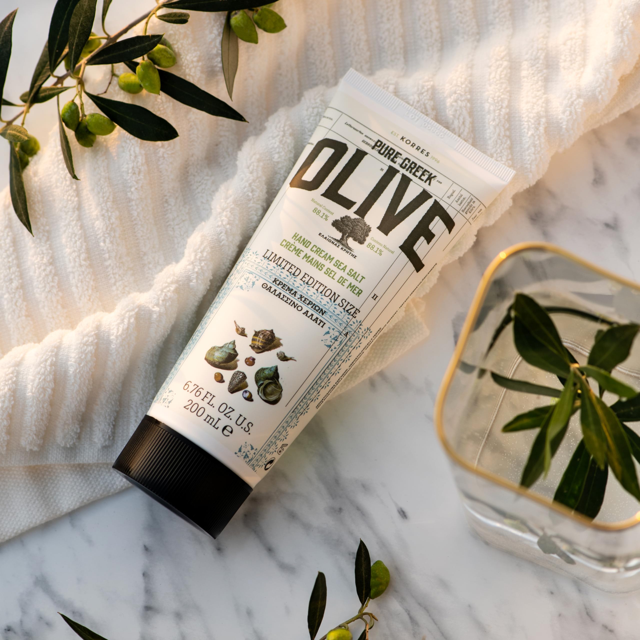 KORRES Olive Body Lotion texture close-up highlights silky finish and rapid absorption.