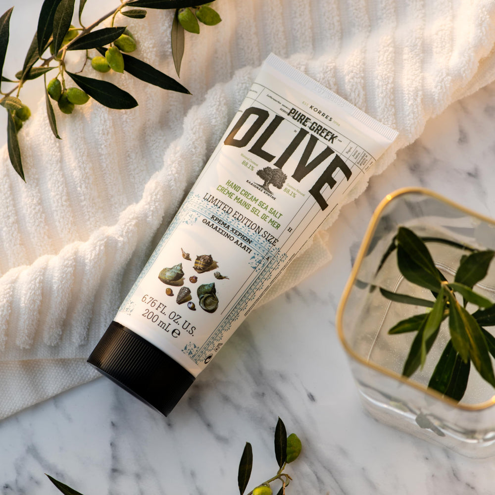KORRES Olive Body Lotion texture close-up highlights silky finish and rapid absorption.