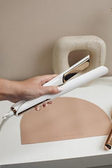 Close-up of Kristin Ess titanium plates for even heat and frizz reduction