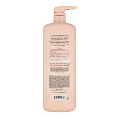 Kristin Ess Hair One Signature Shampoo being poured into palm for cleansing.