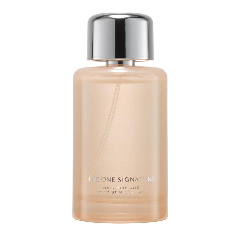 Kristin Ess One Signature Hair Perfume bottle on a vanity for long-lasting freshness.