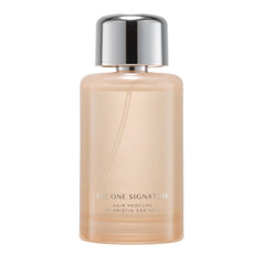 Kristin Ess One Signature Hair Perfume bottle on a vanity for long-lasting freshness.