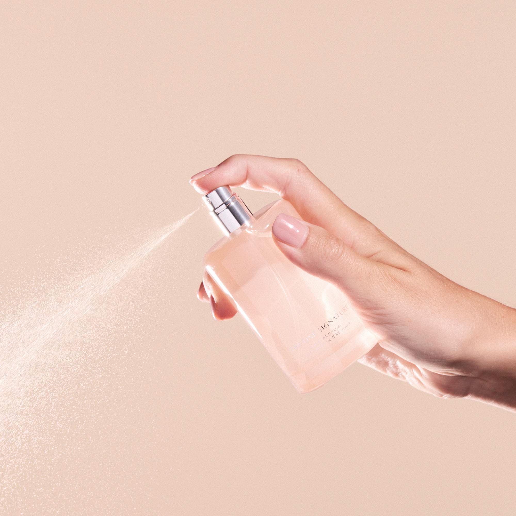 Kristin Ess One Signature Hair Perfume travel case ready for on-the-go refresh.