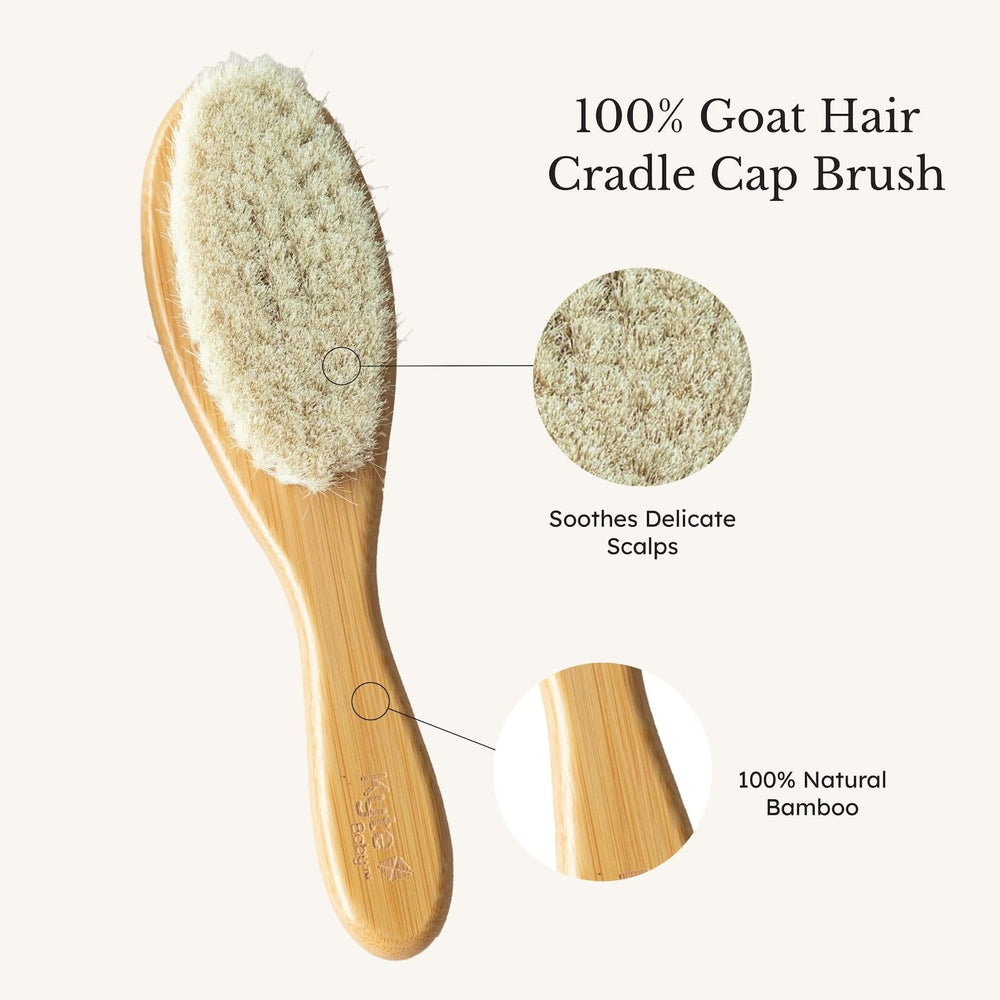 Kyte BABY wooden bristle brush sweeping through fine baby hair.