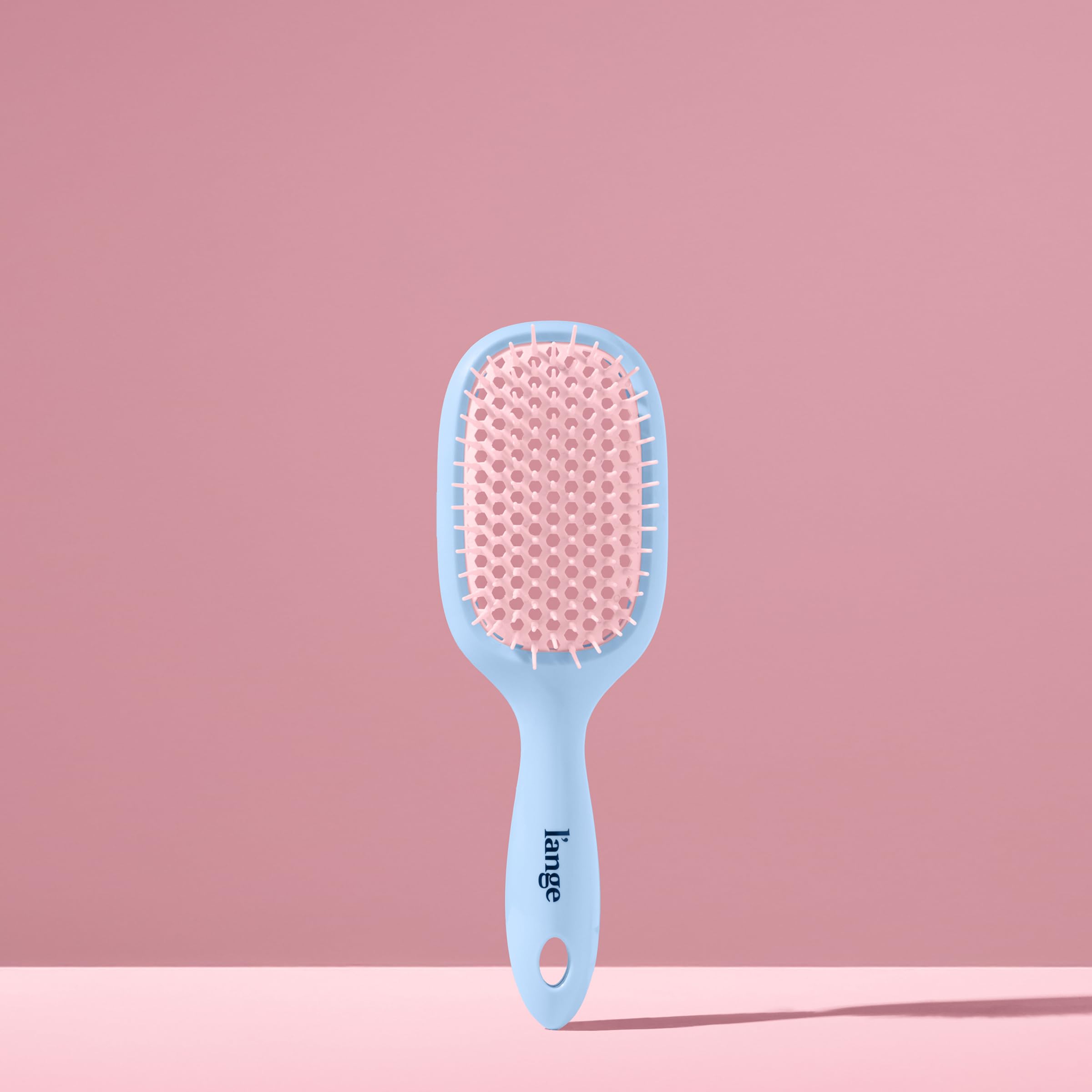 Vented design of the L'ANGE brush distributes conditioner evenly for smoother results.
