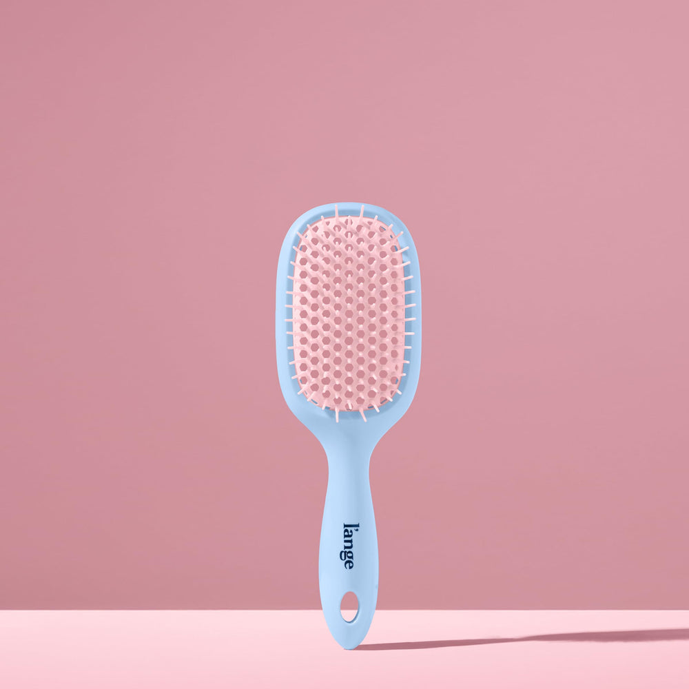 Vented design of the L'ANGE brush distributes conditioner evenly for smoother results.
