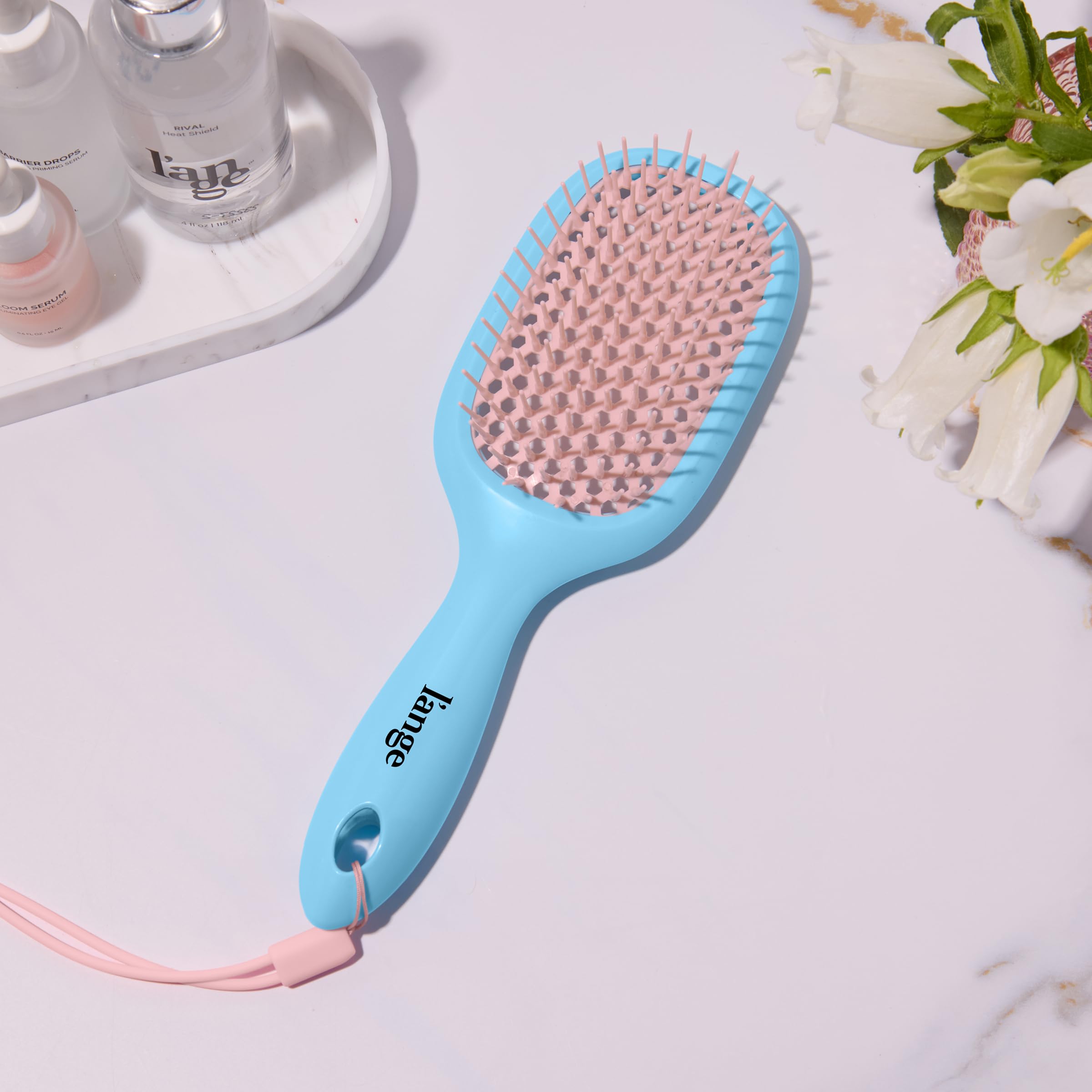 L'ANGE Detangling Vented Brush with ergonomic handle offers comfortable shower control.