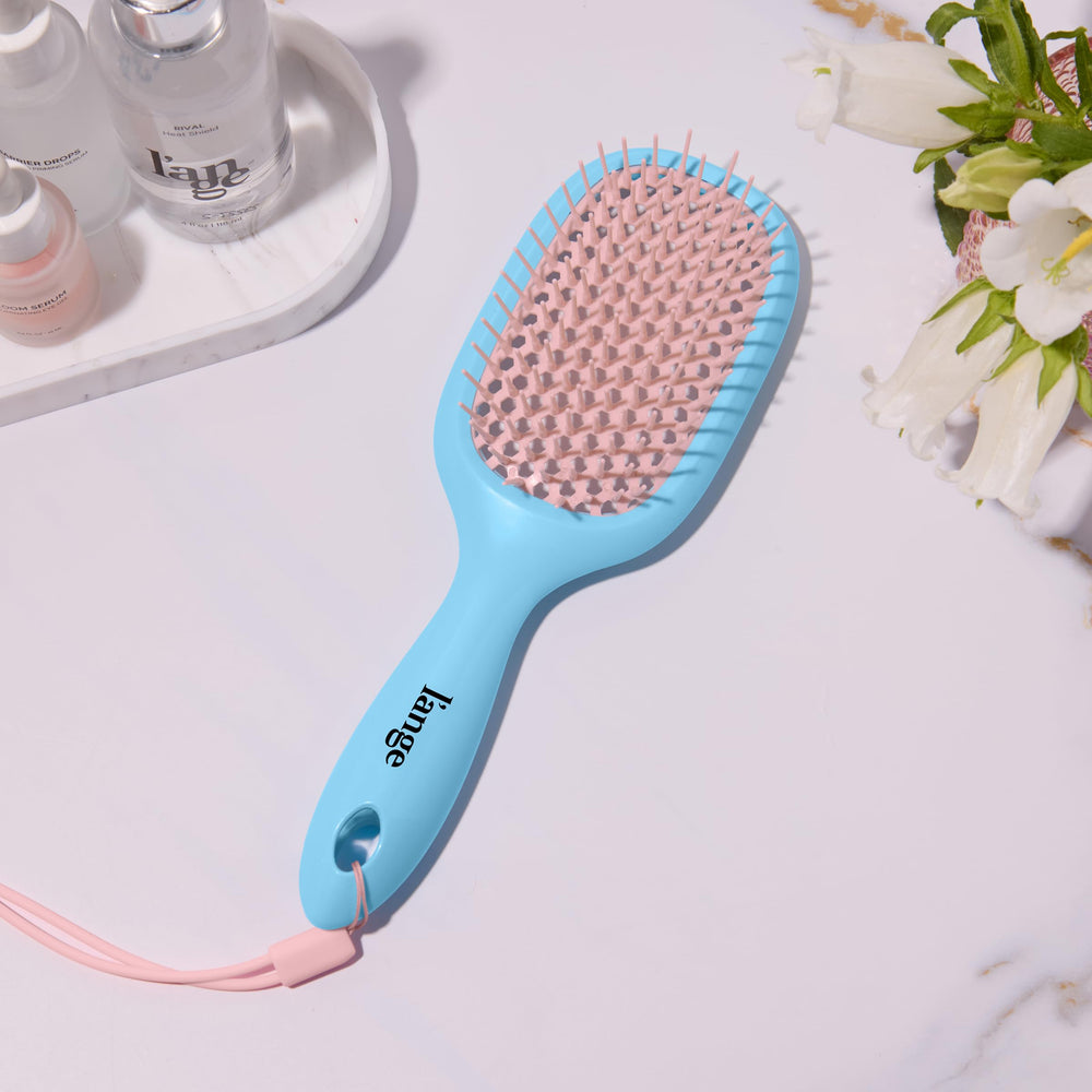 L'ANGE Detangling Vented Brush with ergonomic handle offers comfortable shower control.
