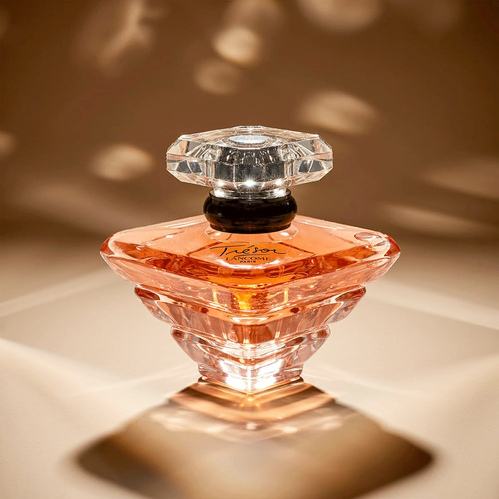 Lancôme Trésor bottle bathed in soft light suggesting romantic wear.