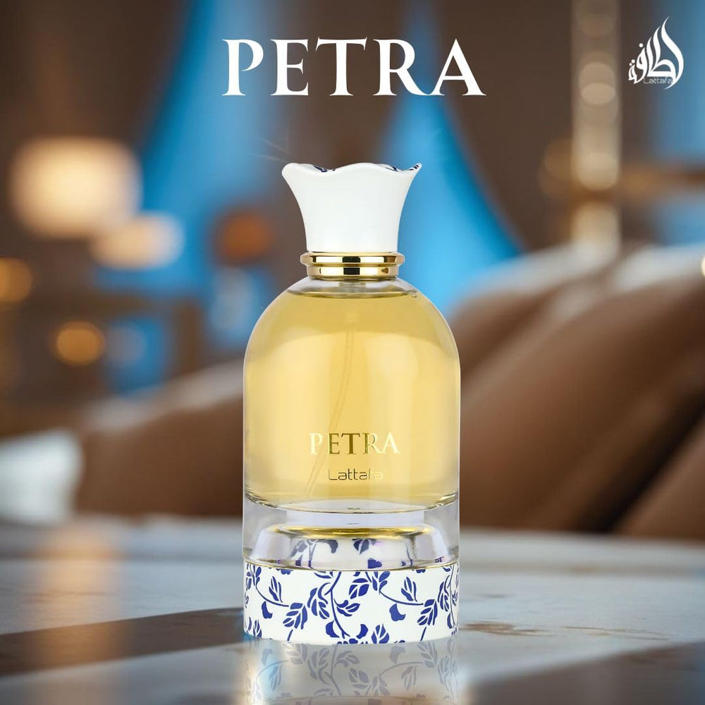 Close-up of glass Petra EDP bottle showing warm amber perfume