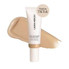 Laura Mercier tinted moisturizer pump bottle demonstrates sheer-to-light coverage.
