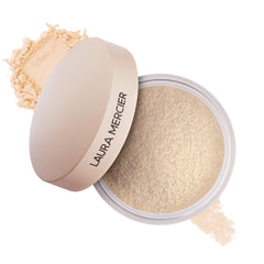 Laura Mercier Ultra-Blur powder jar close-up showing ultra-fine texture for a seamless finish.