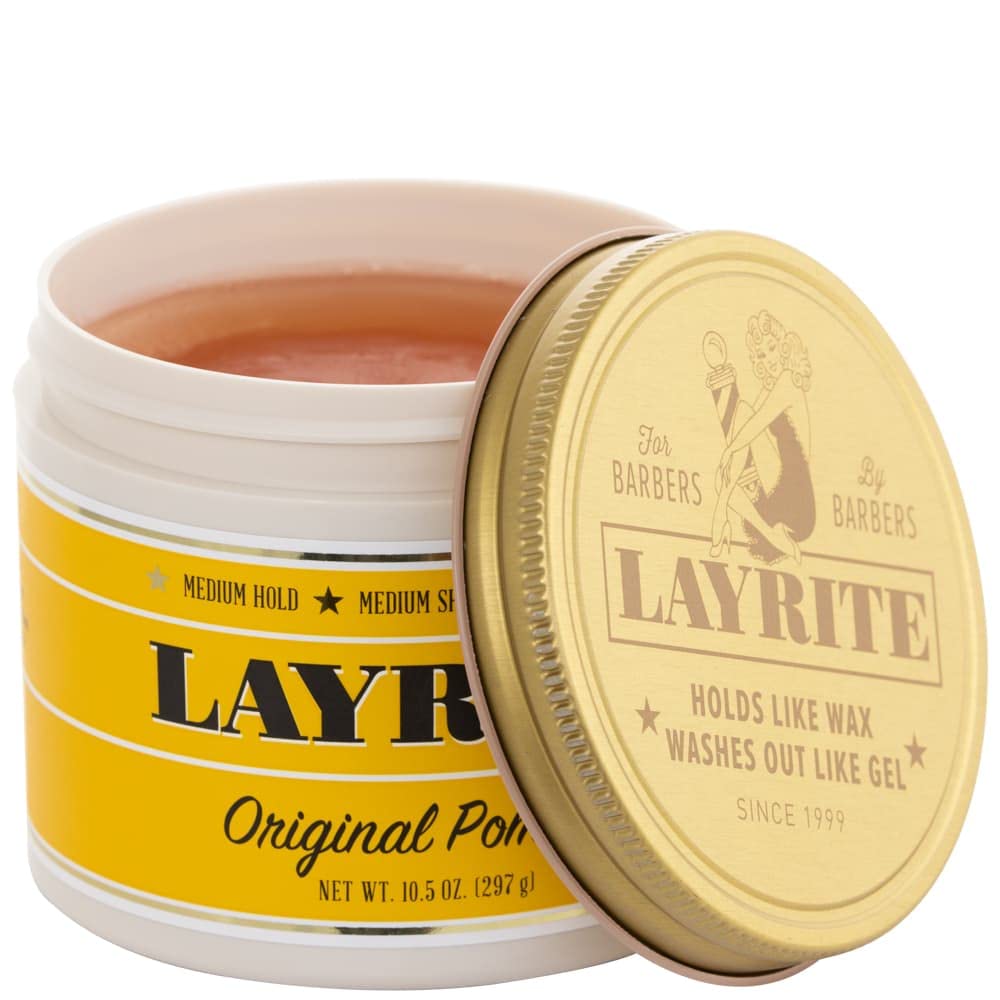 Hands apply Layrite Pomade to short hair for versatile looks.