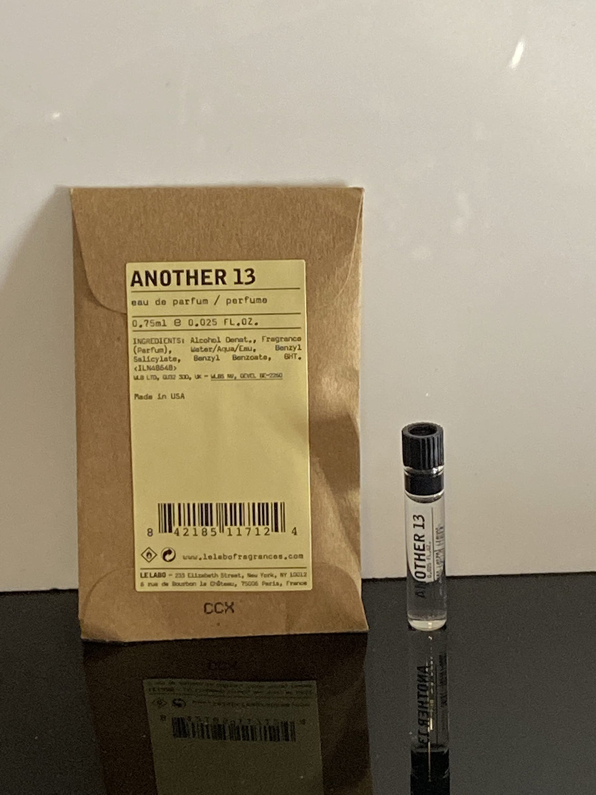 Le Labo Another 13 dabber sample bottle showing compact portability for on-the-go use.