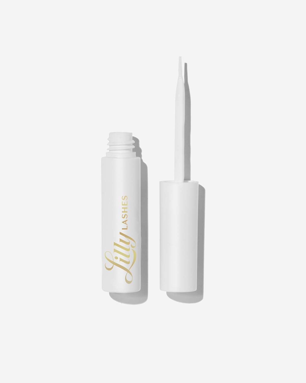 Lilly Lashes clear glue with brush-on applicator for precise lash placement.