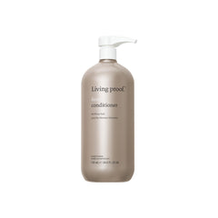 Living Proof No Frizz Conditioner bottle pour showing frizz control in action