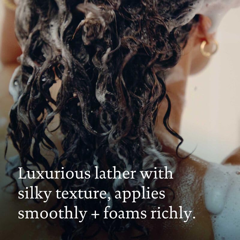 Living Proof Shampoo travel-size closeup on bathroom counter.