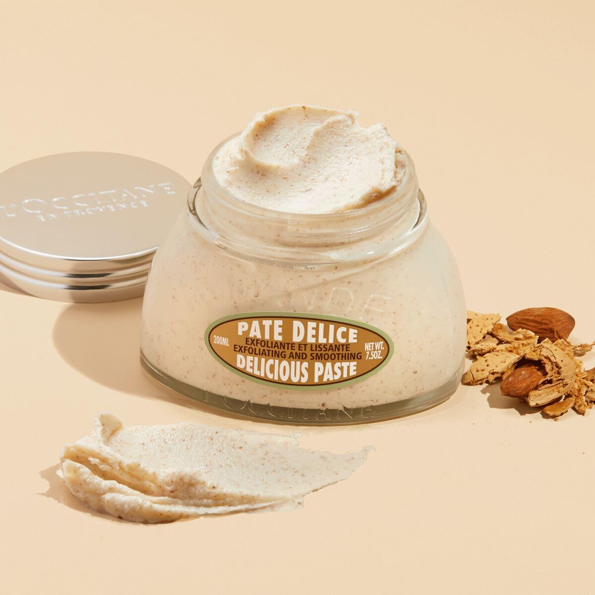 L'OCCITANE almond paste applied to arm for smoothing texture.