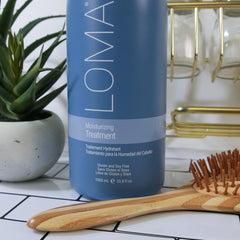 Loma Moisturizing Treatment packaging close-up emphasizes sulfate-free, paraben-free conditioning.