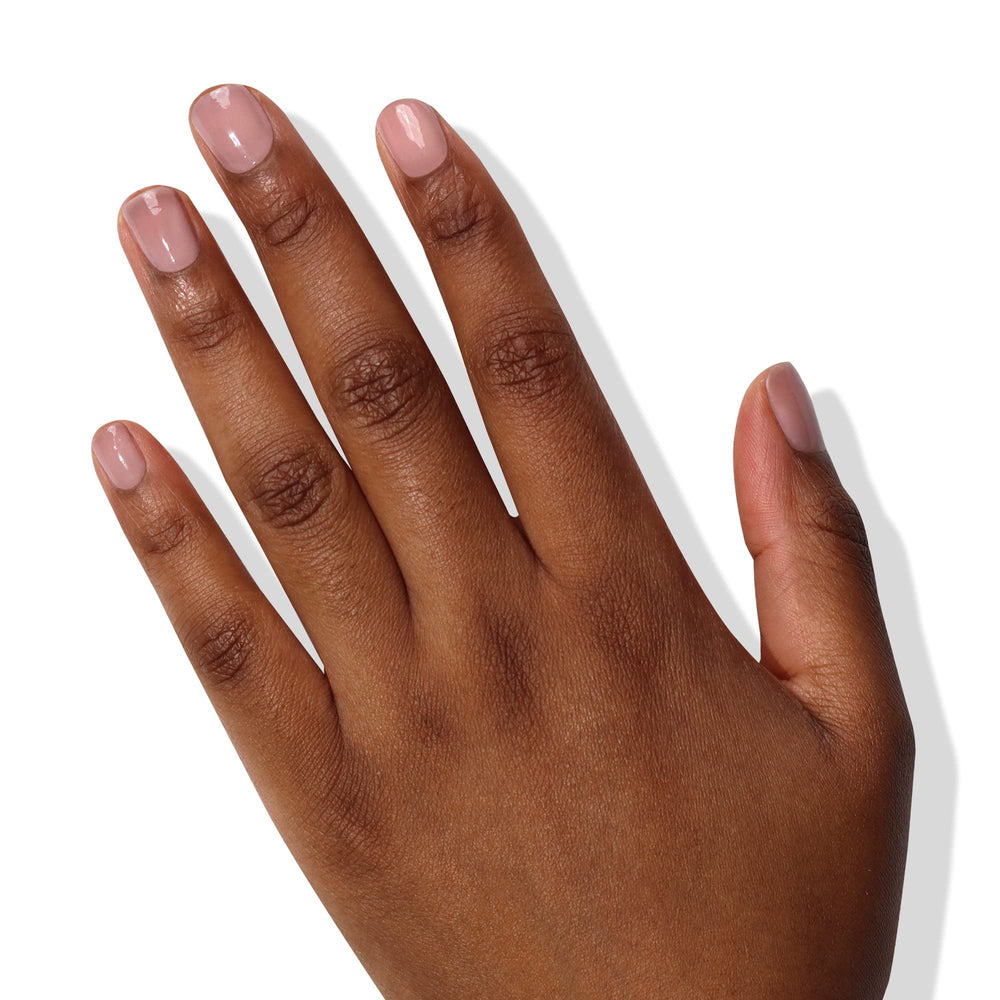 Dusty rose tint on nails demonstrating buildable coverage and sheen.