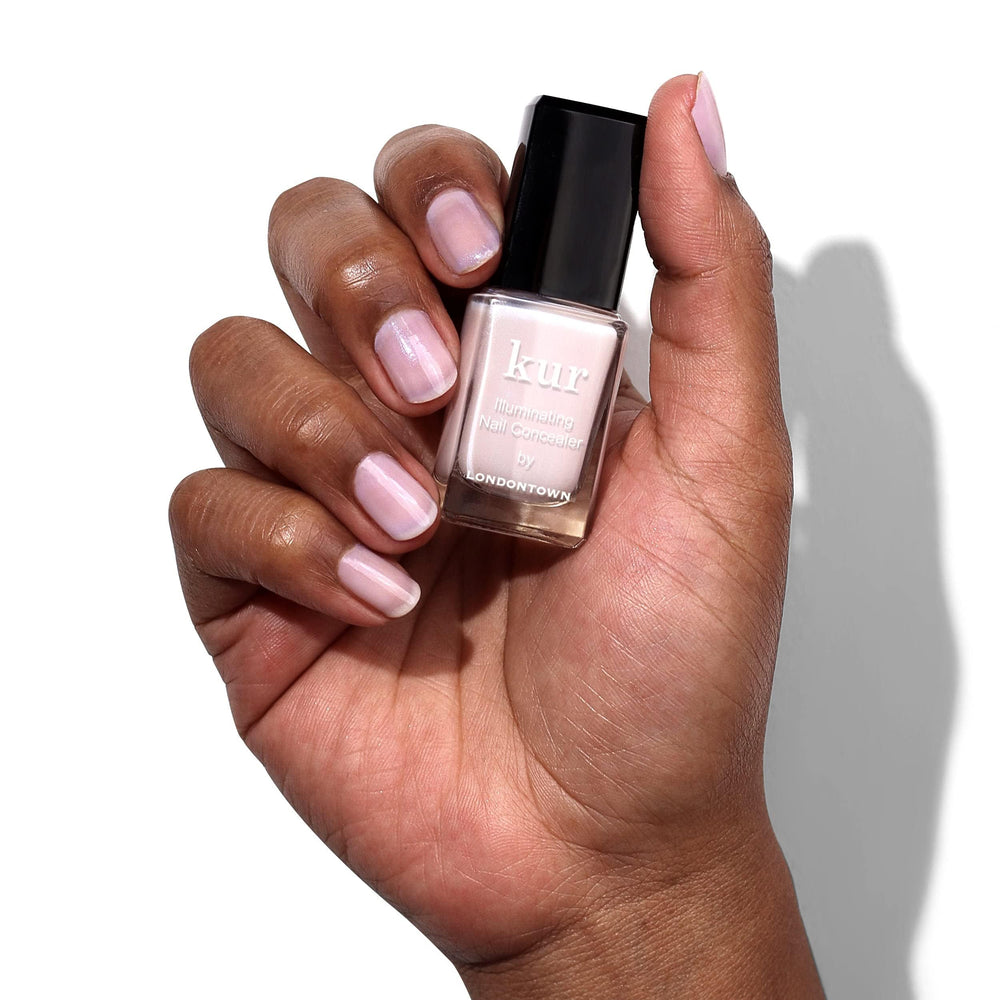 LONDONTOWN kur Pink Illuminating Nail Concealer being applied for even coverage.