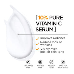 Close-up of serum dropper releasing 10% pure vitamin C onto skin