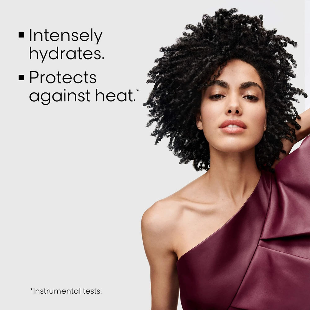 Close-up of the L'Oréal Curl Expression Leave-In Cream bottle with pump for easy application.
