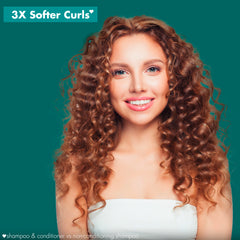 Creamy conditioner texture suggesting detangling and curl nourishment.