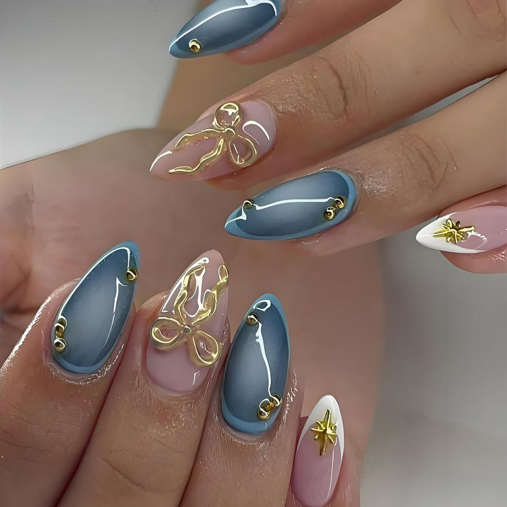 LPOODDNU 3D gold bow star nails with almond blue tips for salon-style at-home manicures.